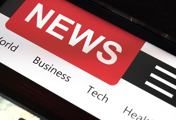 Close up of mobile smart phone with news on screen. Newspaper online portal in browser.
